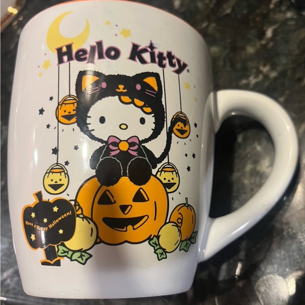 Hello kitty Halloween pumpkin mug. Pictures on both sides of cup
